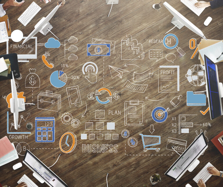 Aerial shot of a marketing brainstorming session with HubSpot displayed on the screen and detailed notes on lead generation steps.